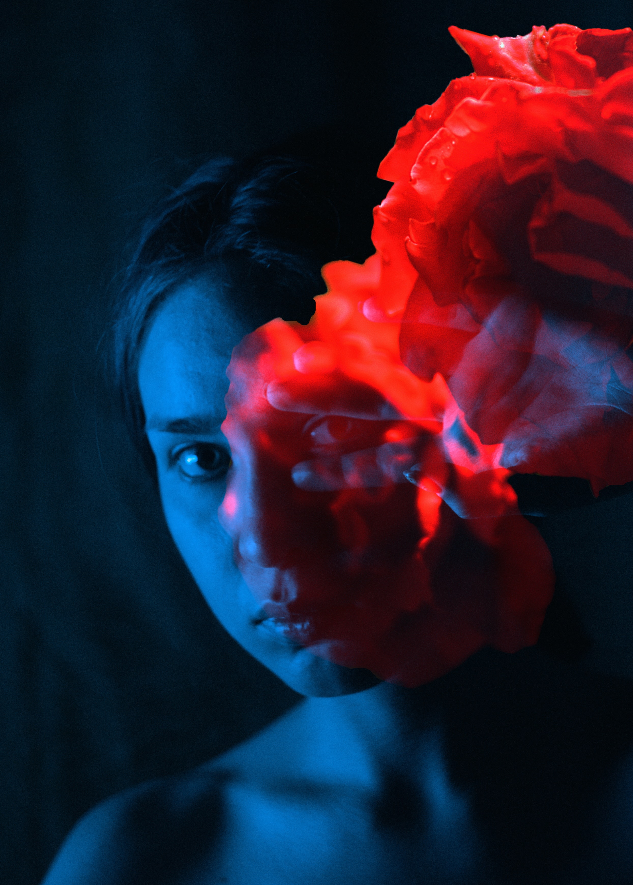 blue light on woman with red flowers in foreground